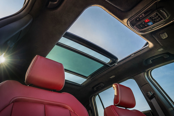 Looking up past the seat head rests at the dual?pane panoramic sunroof of the Jeep Wagoneer S.